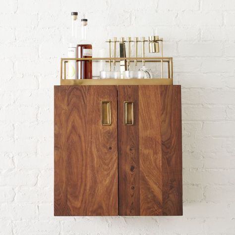 Shop wall mounted bar cabinet.   Lifting cocktails to the next level, modern wooden cabinet thrives in small spaces.  Designed by Kristen Wentrcek and Andrew Zebulon Williams, two doors open via brass pulls to reveal ample storage within. Wall Mounted Bar Cabinet, Mounted Bar Cabinet, Modern Bar Cabinet, Wood Storage Shelves, Wall Mounted Bar, Home Bar Cabinet, Dining Room Furniture Modern, Small Space Storage, Wall Mounted Cabinet