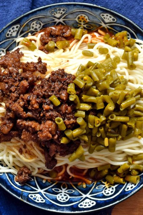 Chengdu Zajiang Mian (成都杂酱面) Sichuan minced meat sauce rests atop a bed of noodles alongside pickled Chinese long beans and underneath it all lies a hidden layer of sweet, savory, and spicy sauce. Chinese Long Beans, Long Beans, Top Ramen, Long Bean, Minced Meat, Spicy Sauce, Meat Sauce, Chengdu, Sweet Savory