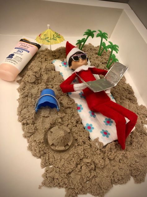 2020 Day 15: Cocoa the Scout Elf made a beach out of kinetic sand so he could relax and work on his tan Elf Beach Ideas, Elf Working Out, Vacation Elf On The Shelf Ideas, Beach Elf On The Shelf, Scout Elf Ideas, Elf On The Shelf Beach Ideas, Elf Kit Ideas, Elf On The Shelf Grinch Ideas, Elf On The Shelf Last Day