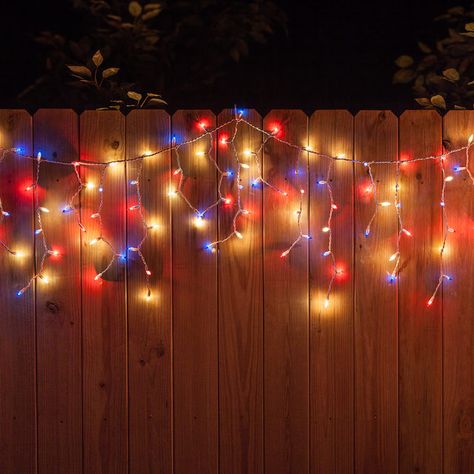 Red, white and blue icicle string lights hanging along a fence for July 4th! Night Decoration, Trunk Ideas, Yard Deck, Fourth Of July Decorations, Blue Lights, Icicle Lights, July Wedding, Senior Night, 4th Of July Decorations