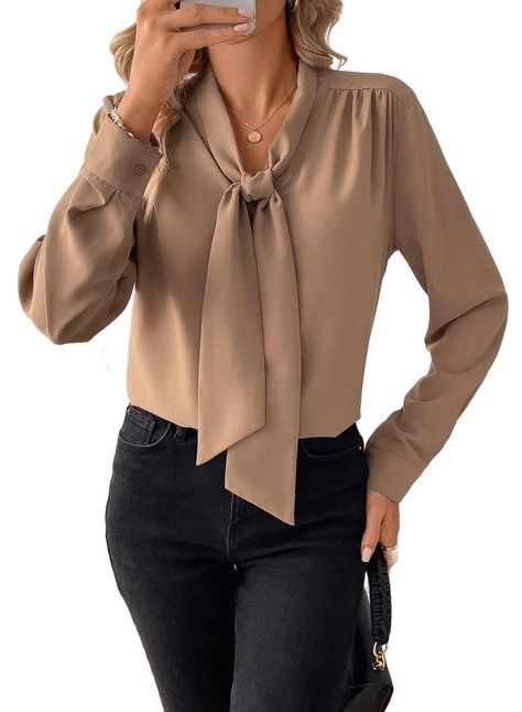 PRICES MAY VARY. Material:made from 100% Polyester,this blouse is crafted from a soft fabric that is incredibly lightweight and flowy,making it comfortable to wear all day Features:this casual blouse has a front bow tie knot style;long sleeves;a V-neckline;solid color;button cuffs.It is perfect for office ladies,makes you stand out in a crowd Matched:this blouse shirt is easy to pair with skirts;jeans;high waist shorts;high-heeled shoes;necklace and earrings,giving you a timeless and stylish loo Blouses For Work Office Wear, Business Blouses For Women, Ladies Work Outfits, Office Tops Blouses Work Wear, Winter Business Casual Outfits For Women, Blouse And Skirt Outfit, Bank Teller Outfit, Tie Knot Styles, Bow Tie Knot