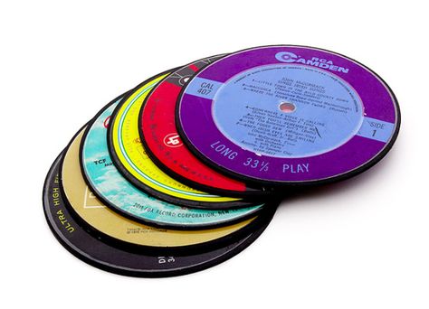 These coasters made from record labels cut from the center of actual vinyl records. | 23 Things Every Music Lover Needs In Their Life Recycled Records, Record Coasters, Coaster Ideas, Cassette Audio, Old Records, Cool Coasters, Music Ideas, Best Stocking Stuffers, Coaster Furniture