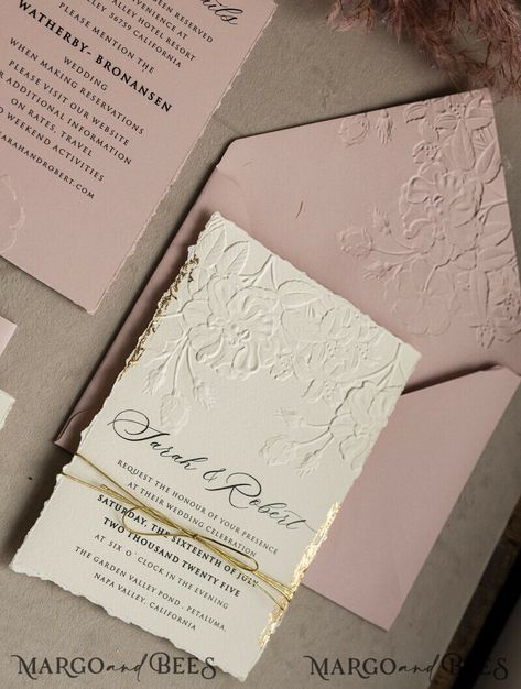 If you're a modern bride looking for sophisticated wedding stationery that exudes elegance without breaking the bank, then look no further than the bespoke embossed blind ivory gold wedding invitation. This popular design combines minimalist aesthetics with luxurious detailing, making it a stunning choice for your special day. The invitation features beautiful embossing that adds a touch of texture and sophistication, while the gold twine adds a subtle hint of glamour. The ivory color scheme giv Floral Embossed Wedding Invitations, Gold Embossed Wedding Invitations, Gold Foiled Wedding Invitations, Wedding Invitation Pink And Gold, Fall Wedding Cards, Boho Style Wedding Invitations, Wedding Invite Gold Foil, Ivory Wedding Invitations, Wedding Invitations Uk