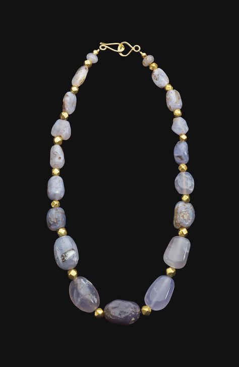 "A WESTERN ASIATIC BLUE CHALCEDONY BEAD NECKLACE CIRCA 2ND CENTURY B.C.-2ND CENTURY A.D. Composed of irregular ovoid beads graduated in size, interspersed with modern gold beads; strung with a modern hook-and-loop closure" (quote) via christies.com Roman Jewellery, Oversized Necklace, Byzantine Gold, Ancient Beads, Necklace Sale, Ancient Jewels, Roman Jewelry, Ancient Jewellery, Greek Vases