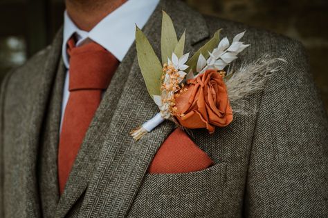 Groom in grey suit with matching orange tie, pocket watch, and rose boutonniere with dried flowers Grey Suit With Terracotta Tie, Green Suit Orange Tie, Grey And Orange Suit, Grey And Burnt Orange Wedding, Summer Wedding Groom Suit, Grey Suit Orange Tie, Suit With Orange Tie, Grey And Orange Wedding, Terracota Wedding