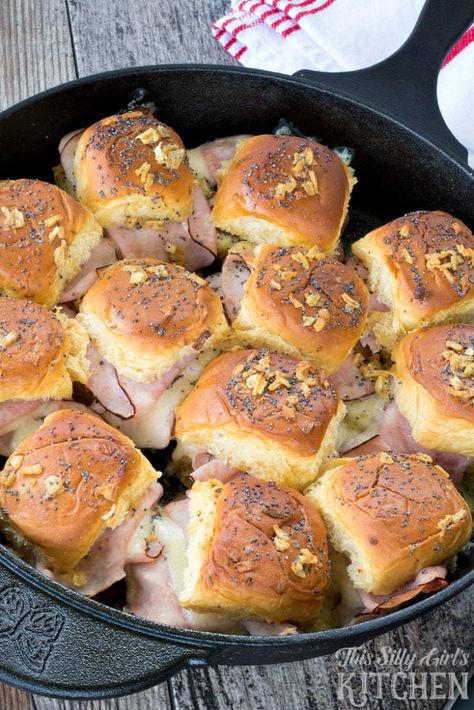 Cast Iron Baked Ham and Swiss Sliders, bursting with flavor, these party sliders are baked in a cast iron skillet and drizzled with a savory butter sauce! from ThisSillyGirlsLife.com @KingsHawaiian #ad Ham And Swiss Sliders, Ham Sliders, Camping Dishes, Camping Desserts, Camping Dinners, Iron Skillet Recipes, Skillet Recipes, Easy Camping Meals, Cast Iron Skillet Recipes