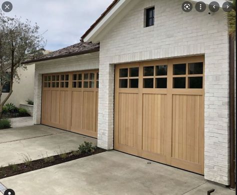 Wooden Garage Doors Farmhouse, Natural Wood Garage Doors White House, White Brick House Wood Garage Door, Wooden Front Door And Garage Doors, Garage Door Ranch Style Home, Nice Garage Doors, Light Wood Front Door Modern, Light Brown Garage Door, Modern Ranch Garage Doors