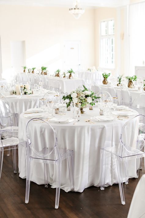 Classic Neutral Wedding Reception Decor, Round Table with White Linen, Low Gold Vase with Ivory and Greenery Floral Centerpiece, Clear Ghost Acrylic Chairs | Tampa Bay Wedding Photographer Lifelong Photography Studio | Wedding Rentals Kate Ryan Event Rentals | Historic Wedding Venue The Orlo Ghost Chairs Wedding Reception, White Drapes Wedding, Ghost Chair Wedding, Neutral Wedding Reception, Classic Neutral Wedding, Burgundy And Grey Wedding, Champagne Decor, Acrylic Chairs, Wedding Reception Chairs