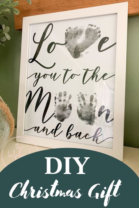 Use your baby's feet and hands to make this adorable love you to the moon and back keepsake. Makes the perfect homemade Christmas present for grandparents, aunts, uncles or just to hang on your wall! Check out my blog post to see how I did this with mess free ink pads and my 10 month old daughter. I have some good tips to help you make this fun and beautiful! Hand Print Art For Grandparents, Valentines Gift From Baby To Daddy, Baby Hand Print Art, Foot Print Crafts For Kids, Hand Print Canvas Ideas, Baby Hand And Foot Prints Crafts, Hand And Footprint Art, Baby Hand And Foot Prints, Baby Christmas Crafts