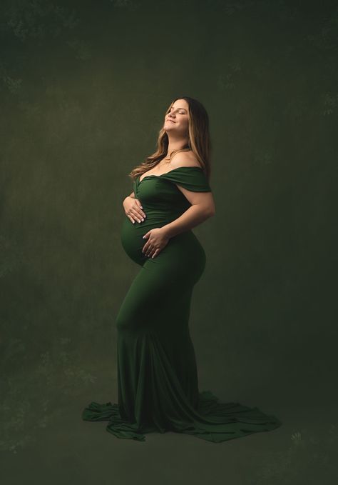 Stunning Momma in our Corrine gown in Moss Green!  Photography by @kaylonjonesphotography #babyshowerdresses #maternitydress #Maternitydresses #maternitygown #maternitygownforphotoshoot #Photography #photoshoot #womensfashion #womensgowns Olive Maternity Dress Photoshoot, Forest Green Maternity Dress Photoshoot, Green Maternity Dress Photoshoot Studio, Maternity Gown Poses, Maternity Photography Big Dress, Maternity Gowns For Photoshoot, Aria Dress, Fitted Maternity Dress, Girls Couture