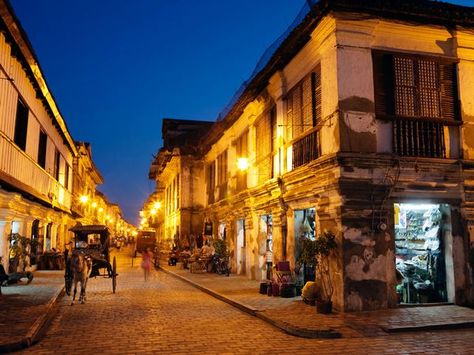 Calle Crisologo, Vigan  Photograph by Laurie Noble/Getty Images    Streetlamps illuminate historic Calle Crisologo in the 16th-century town of Vigan. Located in the province of Ilocos Sur, Vigan’s well-preserved mix of Spanish colonial planning and Asian architectural influences earned it a spot on UNESCO’s World Heritage list in 1999. Calle Crisologo Vigan, Vigan Ilocos Sur, Vigan Philippines, Vigan City, Ilocos Sur, Tacloban City, Filipino Architecture, Philippine Holidays, Boracay Philippines