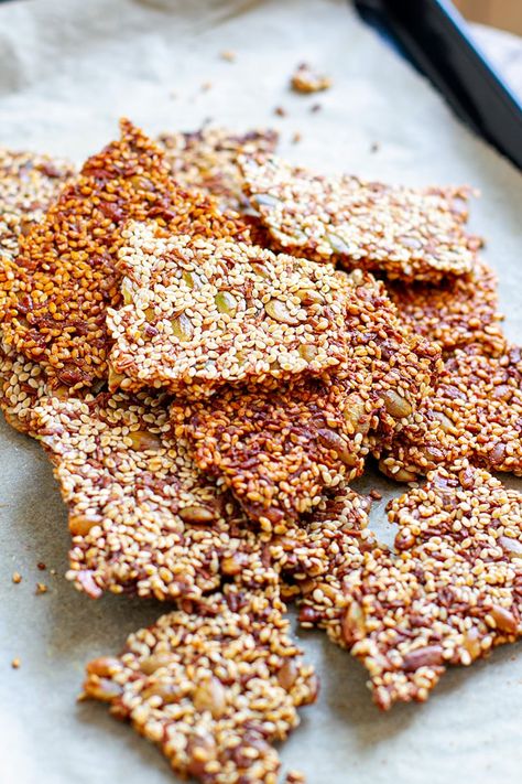 Learn how to make homemade Sesame Snaps (Paleo, Gluten-Free, Nut-Free). Great as a snack or a treat, these are made with sesame seeds, pumpkin seeds, brown rice syrup, and a touch of vanilla and honey. Takes 20 minutes and keeps for 2 weeks. Gluten-free, nut-free, paleo, vegan-friendly (swap honey for maple syrup). #sesamesnaps #sesame #sesameseeds #snacks #paleo #glutenfree #nutfree #vegan #plantbased