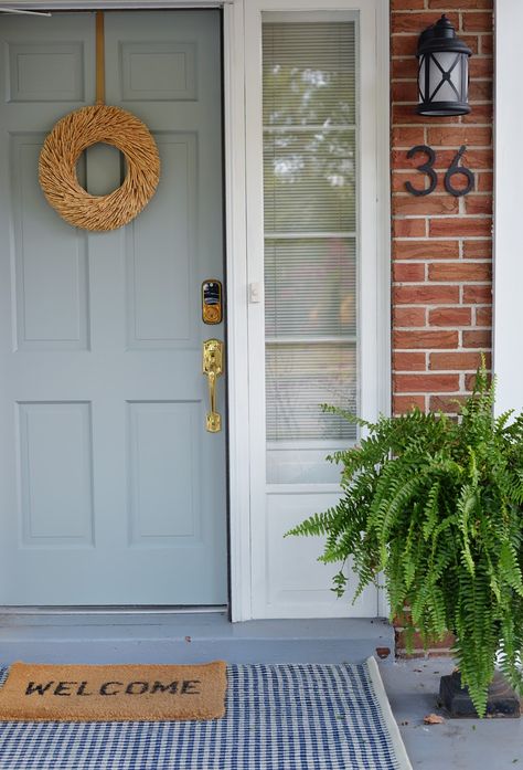 Porch Decorating Ideas For Summer, Brick House Front Door Colors, Rug Ikea, Carriage Style Garage Doors, Front Porch Decorating Ideas, Metal Garden Benches, Blue Front Door, Cottage Porch, Welcome Signs Front Door