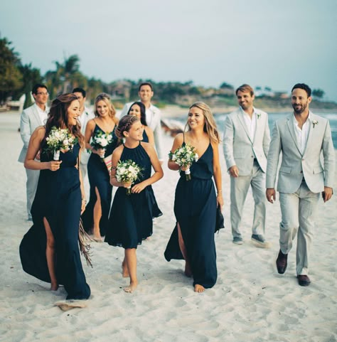 Beach wedding bridesmaids in navy blue dresses and groomsmen in grey suits Navy Blue Beach Wedding, Beach Bridesmaid, Beach Wedding Outfit, Blue Beach Wedding, Beach Bridesmaids, Navy Blue Bridesmaids, Grey Suits, Beach Wedding Bridesmaids, Navy Bridesmaids