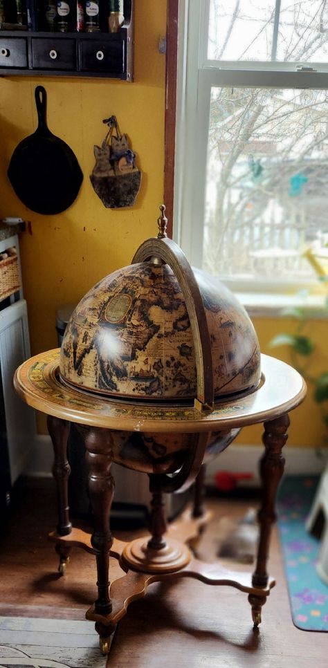 This vintage bar is PICK UP ONLY near Warrensburg ILLINIOS.  This Achilles liquor cabinet is an antique style wood globe that rotates, and its on casters so it can easily be moved. The globe outer surface is layered in a printed reproduction 16th century map, has zodiac signs and dates on wood trim, and your guests will be so intrigued by the art on upper inner globe, with old world angels, gods, and creatures with latin quotes. Translations may be "the propaganda of faith", "to die or be offended".( we don't know latin, lol, but tried google) The globe opens at the equator to reveal an Old Masters type art imprinted to bottom surface. It also has a covered ice bucket with liner, and an area capable of holding glasses and stemware, shaker and your favorite liquors.  This globe bar measures Globe Alcohol Cabinet, Globe Liquor Cabinet, Antique Style Home, Alcohol Cabinet, Globe Furniture, Globe Bar, Old Globe, Serving Bar, Latin Quotes