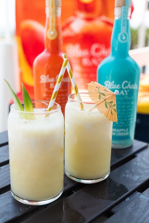 Sip back and relax with this delicious frozen mango colada. Make this rum cream cocktail your summer drink. This drink requires few ingredients making it easy to make. Just grab Mango and Pineapple Rum Cream, pineapple juice, and ice. Enjoy is at the beach or by the pool. Click here for the recipe. #bluechairbay #BCBHappyHour #mangorumcream #summercocktail #rumcocktail #rum #rumcream #drinkrecipe Pineapple Rum Cream Drinks, Mango Rum Drinks Recipes, Mango Rum Drinks, Banana Cream Rum Drinks Recipe, Banana Rum Cocktails, Blue Chair Bay Mango Rum Cream Recipes, Blue Chair Bay Coconut Spiced Rum Cream, Blue Chair Key Lime Rum Cream Drinks, Blue Chair Bay Pineapple Rum Cream