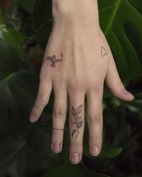 30+ Trendy And Charming Hand Tattoos For Women Genie Lamp Tattoo, November Tattoo, Aladdin Tattoo, Back Of Hand Tattoos, Lamp Tattoo, Handmade Tattoo, Literary Tattoos, Genie Lamp, Triangle Tattoos