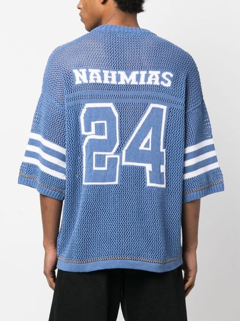 knitted oversize baseball T-shirt from NAHMIAS featuring blue tint, off-white, cotton-linen blend, knitted construction, openwork areas, intarsia knit, logo patch to the side, intarsia-knit logo, ribbed V-neck, drop shoulder, short sleeves and straight hem. This item contains at least 50% materials which are certified or widely recognised as having a lower environmental impact through production and/or manufacturing processes that reduce water consumption and the use of harmful chemicals, or re- Knit Streetwear, Baseball Shirt Designs, Graphic Shirt Design, Light Blue Knit, Football Sweater, Earthy Outfits, Concept Clothing, Knit Logo, Water Consumption