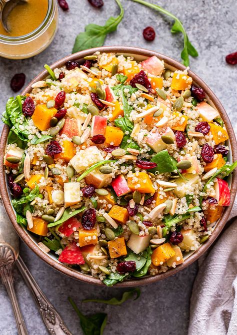 Overhead photo of Harvest quinoa salad with butternut squash, apples, dried cranberries, pepitas, spinach, and toasted almonds in a white serving bowl. A jar of cider vinaigrette behind the bowl. Squash Quinoa Recipes, Fall Quinoa Salad Recipes, Salad Halloween, Salad With Nuts, Fall Quinoa Salad, Fall Quinoa, Recipe Runner, Savory Quinoa, Squash Quinoa