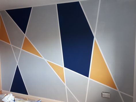 Geometric wall navy gray yellow Geometric Wall Painting, Accent Wall Bedroom Paint, Geometric Accent Wall, Wall Painting Designs, Khaki Walls, Geometric Wall Paint, Wall Art Yellow, Family Photo Wall, Flat Decor