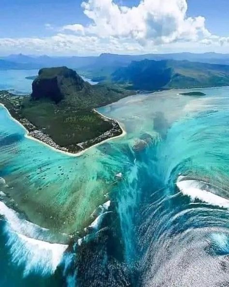 The optical illusion near Mauritius that creates the appearance of an underwater waterfall is indeed a fascinating natural phenomenon. It occurs off the southwestern coast of Mauritius, near Le Morne Brabant peninsula. The illusion is created by sand and silt deposits on the seabed that create a stark contrast in water depths, giving the impression of a cascading waterfall under the ocean's surface. Le Morne Mauritius, Underwater Waterfall, Nature Wonders, Cascading Waterfall, Under The Ocean, Natural Phenomena, Optical Illusion, Optical Illusions, Mauritius