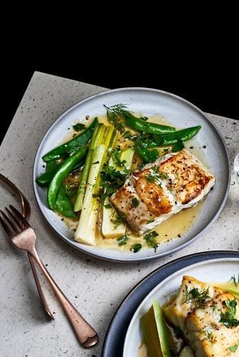 Swimming in a broth infused with butter, lemon, and white wine, this crispy fish makes an easy and elegant weeknight dinner. Cod And Leek Recipes, Fish Summer Recipes, Summer Cod Recipes, Leek Sauce For Fish, Fish And Leeks Recipe, Good Friday Recipes Dinners, Summer Dinner Recipes Fish, Summer Fish Dinner, Summer Fish Recipes