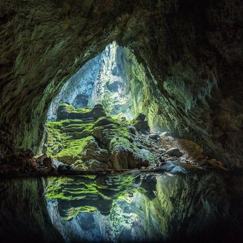 Vietnam | Discovered by Ho Khanh in 1990, Hang Son Doong has emerged as the world’s largest cave both by volume and by cross section, making for a breathtaking view from the cavern’s mouth. The cave is home to 230ft stalagmites and entire forests of trees, grown beneath massive openings in the cave’s ceiling. Nearby in the same Phong Nha-Kẻ Bàng National Park is Hang En, the world's third-largest cave. Some tour groups offer the chance to camp inside. Son Doong Cave, Cave Photography, Dong Hoi, Vietnam Voyage, Video Nature, Jungle Adventure, Salou, Adventure Tours, Beautiful Places To Visit