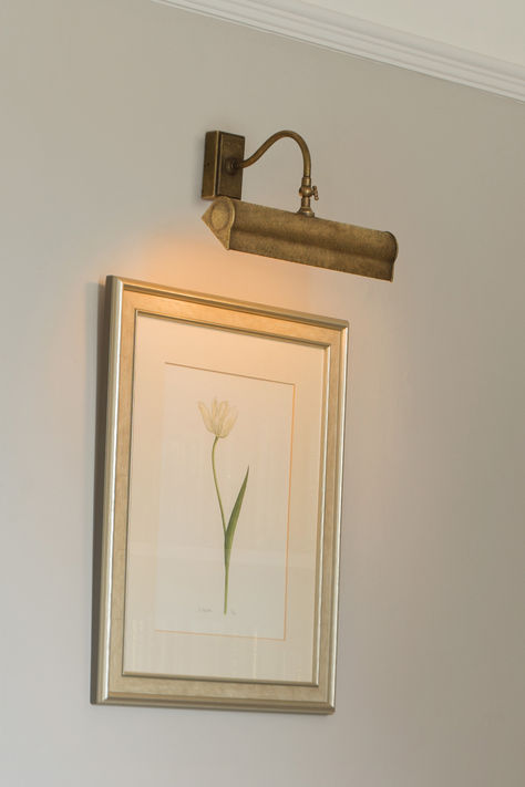 If you are looking for picture lighting ideas, our elegant Halifax Picture Lights are among the best as they combine a traditional looking light with the latest LED technology.  Our Halifax Picture Light is made from solid, natural brass that has been lightly antiqued to give it a subtle, aged appearance, and has a weighty quality that befits its handmade nature. It has a gently curving arm and slightly flared rim that can be adjusted back and forth with the decorative screw pin. Picture Lighting Ideas, Brass Picture Light, Picture Lighting, Adjustable Wall Light, Picture Lights, Designer Wall, Product List, Traditional Modern, Wall Lighting