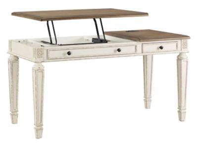 Elevating the art of traditional cottage styling, the Realyn desk is your heavenly home office realized. Antiqued two-tone aesthetic blends a chipped white with a distressed wood tone top for added charm. Framed drawer fronts, decorative corbels and elegantly turned and tapered legs add refinement, while dark bronze-tone knobs lend a classic touch. Spring lift top raises the surface to a comfortable standing position, for a healthy alternative. Built for looks and productivity, the built-in ...