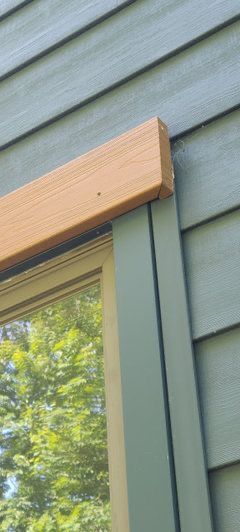 Cedar Trim Exterior Window, Wood Trim Around Windows Exterior, Cedar Header Above Window, Exterior Windows Trim Ideas, Cedar Exterior Door, Exterior Window Header, Wood Beam Window Header Exterior, Wood Headers Over Exterior Windows, Wood Above Windows Exterior