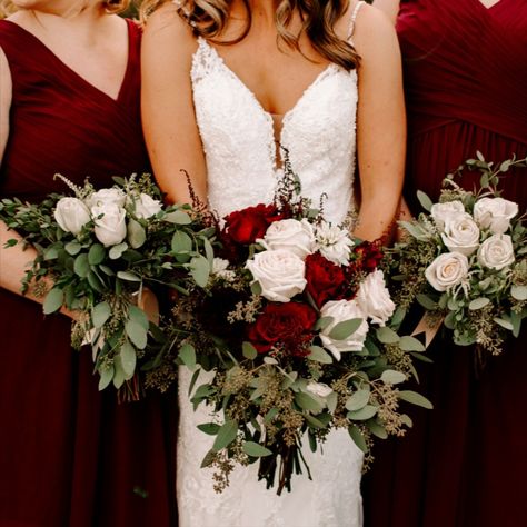 The bride carried a whimsical, loose style bouquet with fresh burgundy and white dahlias, burgundy heart roses, and ivory garden roses, accented with burgundy astilbe, in a bundle of seeded and gunni eucalyptus. The bridesmaids carried a bouquet with ivory roses and greenery. The groom wore a large burgundy dahlia boutonniere, accented with seeded eucalyptus and white astilbe and his groomsmen wore ivory spray rose boutonnieres with seeded eucalyptus in perfect complement. Bride Bouquet Burgundy, White And Burgundy Bouquet, White Green And Burgundy Wedding Flowers, Burgundy And Sage Bouquet, Burgundy Bridesmaid Bouquet, Burgundy And White Wedding, Maroon And Green Bouquet, White And Maroon Bouquet, White Green Burgundy Bouquet