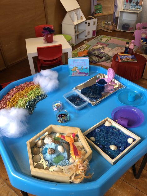 Mermaid themed sensory tray based on the “That’s not my mermaid book” Mermaid Tuff Tray Ideas, Seaside Tuff Tray Eyfs, Rainbow Fish Tuff Tray, Mermaid Messy Play, Under The Sea Tough Tray, Mermaid Book, Playgroup Ideas, Sensory Tray, Mermaid Books