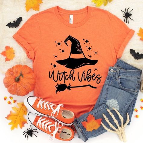 LIMITED EDITION!! LIKE IT? SNAG IT NOW! WE HAVE VERY LIMITED QUANTITIES OF THESE SHIRTS AND ONCE WE ARE SOLD OUT, WE CANNOT GUARANTEE A RESTOCK. Unisex fit and sizing Gorgeous heather orange shirt, perfect for Halloween Stretchy soft premium cotton poly blend material Fits a little large/oversized on women, however, we only recommend sizing down if you prefer to wear your shirts more fitted. Fits true to size on men. Size guide located in photos section Diy Halloween Shirts, Halloween Shirt Design, Witch Vibes, Clothes Wishlist, Orange T Shirts, Orange Shirt, Vibe Clothes, Shirt Fits, Style Shirt