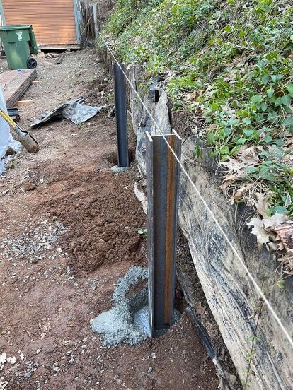 This is a BIG and expensive project! We have several retaining walls on our property that need to be redone. The photo below shows just one of the walls that is falling down (we are looking at the lower wall, light green wood). We decided to tackle these walls one section at a time, as money and time allow. If you are looking for a way to build/replace retaining walls, doing this yourself will take time and muscle, but save you thousands of dollars. (By the way, the fenced in "boxes" u… Wood Retaining Wall, Diy Retaining Wall, Backyard Retaining Walls, Concrete Retaining Walls, Sloped Backyard, Landscaping Retaining Walls, Front Yard Landscaping Simple, Front House Landscaping, Retaining Walls