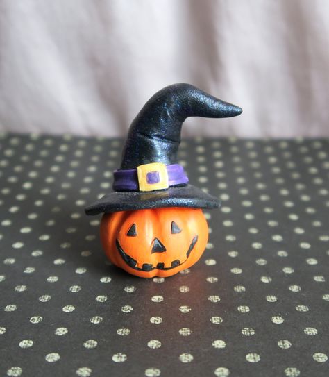 Jack-o-lantern with Witch Hat Handmade Collectible Mini  Great for Halloween this cute little pumpkin has a jack-o-lantern face and a sparkly witch hat. It is much nicer in person- The color may vary on screen and it is a bit hard to see the sparkles.  It is hand painted with nice variations and feels like a high quality miniature to add to any display. Great for dollhouse or miniature village scenes- As you can see in pics, it looks great with other Furever Clay minis that are available in my s Clay Witches Hat, Halloween Clay Figures, Clay Witch Hat, Halloween Clay Crafts, Polymer Halloween, Diy Halloween Village, Polymer Clay Witch, Fimo Halloween, Clay Witch