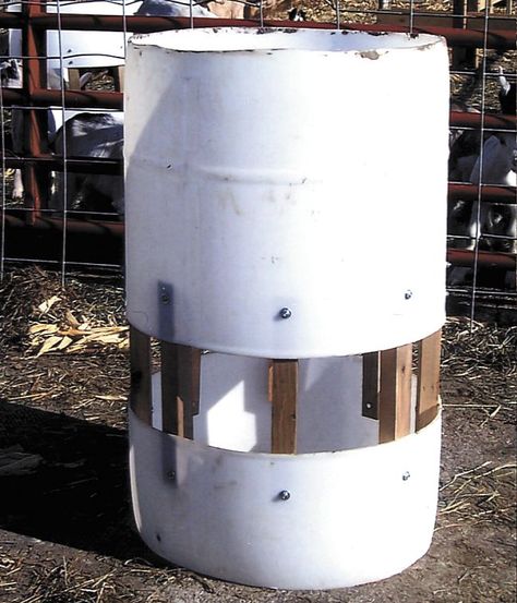 Plastic 55-gal. barrels can be converted into inexpensive sheep and goat feeders that are easy to clean and move around, says David Rottink, Clarksville, Iowa.   He buys the barrels from a l... Goat Yard, Goat Feeders, Sheep Feeders, Goat Hay Feeder, Homestead Projects, Goat Feeder, Sheep And Goat, Hay Racks, 55 Gallon Drum