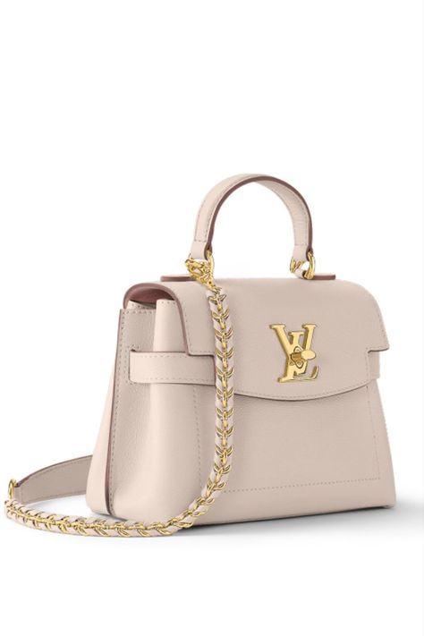 The adorably sized Lockme Ever Mini handbag in grained calf leather is edited this season in fashionable new colorways. Sophisticated lines and a signature LV lock make this model a stylish companion for daily wear or evenings out. The elegant braided chain invites cross-body or over-the-shoulder wear; the top handle is ideal for a feminine hand carry. Lockme Ever Mini, 2023 Handbags, Dream Handbags, Louis Vuitton Lockme, Fancy Stuff, Mini Handbag, Beautiful Handbags, Mini Handbags, Vuitton Bag