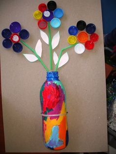 Cute flower project. Use a plastic bottle for the vase and bottle caps for the flower petals. A great recycled craft.    #recycledcrafts #kidscrafts #kids Waste Material Craft Ideas, Waste Material Craft, Water Bottle Crafts, Recycled Crafts Kids, Diy Summer Crafts, Recycled Art Projects, Waste Material, Earth Day Crafts, Bottle Cap Art