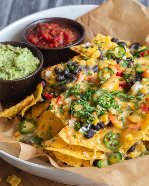 When it comes to game day party grub, these Loaded Vegetarian Nachos are a surefire winner! 🏈 🎉 Layers of crunchy tortilla chips, black beans, corn, bell pepper, red onion, jalapenos, and ooey gooey melty cheese 🧀 come together to create the perfect touchdown-worthy snack! 🙌 Serve these mouthwatering veggie nachos with an array of your favorite dips like sour cream, salsa, and guacamole. 🍅🥑 Comment "nachos" below for the recipe! #SuperBowlFeast #GameDayEats #NachosForTheWin #vegetariannac... Nachos With Jalapenos, Nachos Vegetarian, Veggie Nachos, Salsa And Guacamole, Salsa Nachos, Vegetarian Nachos, Black Beans Corn, Vegan Nachos, Game Day Party