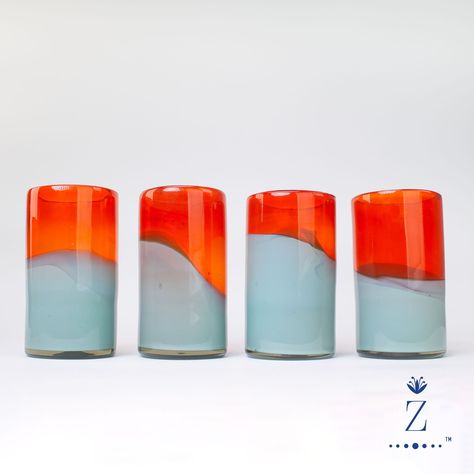 Accentuate your drink-ware collection with handblown Candy Glass Tumblers. Tall vibrant bi-color mandarin & teal cups add bold color variation with sense of sophistication to any gathering. A Zenwaro design, these eclectic vessels are crafted from 100% recycled glass by free-thinking master artisan glassblowers. Drink-in the creativity!  Available individually, set of 2 , set of 4, or set of 6. 100% handmade from recycled materials, these Tumblers and all of our Movement glassware is toxin free Hand Blown Glass Cups, Colorful Glassware, Mexican Glassware, Colorful Cocktails, Cocktail Glassware, Drink Ware, Aqua Glass, Glass Tumblers, Hand Forged Iron