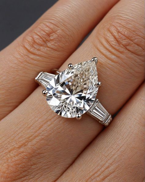 Pear-Cut Diamond Engagement Ring with Baguette Accents Pear Engagement Ring Baguettes, Pear Engagement Ring With Baguettes, Pear Engagement Ring With Tapered Baguettes, Classic Pear-shaped Baguette Diamond Jewelry, Diamond Rings Pear, Luxury Baguette-cut Diamond Ring For Proposal, Ring With Baguettes, Pear Cut Diamond Engagement Ring, Halo Engagement Ring Emerald