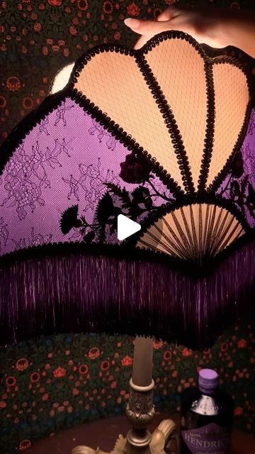 Ace of Shades on Instagram: "I was commissioned by the lovely folks at Accidentally Wes Anderson (@accidentallywesanderson) to create this lampshade inspired by the decadence of Hendrick’s Grand Cabaret Gin from their Cabinet of Curiosities collection! 💜✨ I used the colors of the bottle to custom dye the silks and fringe, incorporated rose appliqués as it’s one of their signature ingredients, and incorporated thistle appliqués to represent Scotland, where it’s distilled. Grand Cabaret is inspired by a fruit-based libation that was in vogue in Paris in the early 20th century—a time and place that inspires my designs greatly. Thanks to Amanda and Wally for this amazing opportunity!  #AdventureCuriously #AccidentallyWesAnderson #handmadelampshades #artdeco #artnouveau #victorian #victorianla Ace Of Shades Lampshades, Ace Of Shades, Accidentally Wes Anderson, Handmade Lampshades, Cabinet Of Curiosities, Diy Lamp Shade, Wes Anderson, Diy Lamp, Lampshades