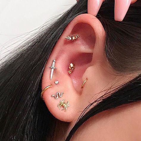 Archives: just in time for Halloween, Savannah’s spooky ear from a couple years ago. I stacked her 3rd hole with a diamond, pierced her 4th with this white gold dagger and conch with this giant gold skull. All of these pieces are available for custom ordering (email only please)! #newyorkadorned #piercer #piercing #allgoldeverything #safepiercing #piercingsofinstagram #piercinginspiration Goth Ear Piercings, Different Ear Piercings, Horn Pendant Necklace, Cute Ear Piercings, Cute Piercings, Types Of Piercings, Swarovski Necklace, Skull Earrings, Rhinestone Designs