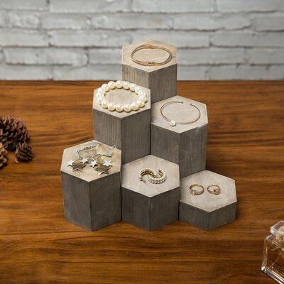 Display your jewellery and accessories in an artful way with these hexagonal wood riser stands. Designed to compliment any aesthetic while providing the ideal backdrop for your cherished keepsakes, this offsetting set of wooden blocks have a rustic, vintage look and feel. Arrange in a straight line, or group together for an interesting look. Each wooden block can be used for a variety of display purposes, whether at home or at a retail store. Store these beautiful display riser racks on any dres Military Coin Display, Wooden Jewelry Display, Custom Wood Boxes, Trophy Display, Bow Display, Wood Display Stand, Display Risers, Coin Display, Pencil Cup