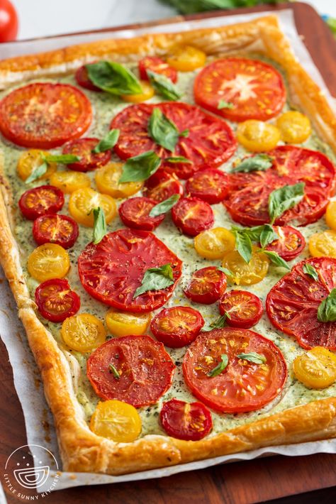 This easy and beautiful Tomato Tart is topped with herbed ricotta cheese and juicy tomatoes. Made with puff pastry, it's ready in under 40 minutes. Tomato Pesto Tart, Boat Appetizers, Easy Tomato Tart, Herbed Ricotta, Tomato Tart Recipe, Puffed Pastry, Easy Tart Recipes, Little Sunny Kitchen, Vegetable Tart