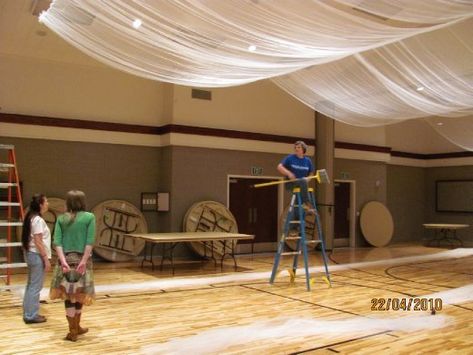 Carol and Sherry decorating a gymnasium for a wedding - Post Falls, Idaho - USA - WorldNomads.com Gymnasium Wedding Decor, Wedding In A Gymnasium, Gymnasium Wedding Reception, Gymnasium Decorations, Gymnasium Reception, Fabric On Ceiling, Gym Wedding Reception, Swag Fabric, Gym Ceiling