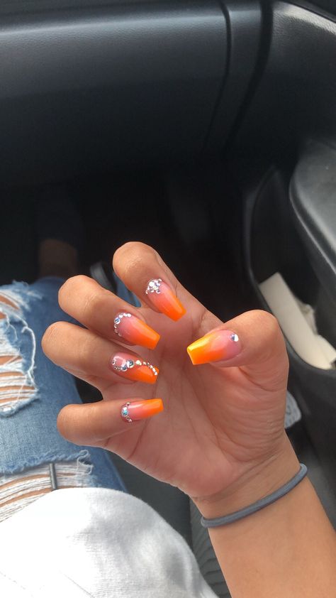 Orange Nails With Jewels, Coral Orange Nails Acrylic, Short Orange Nails With Rhinestones, Bright Summer Nails With Rhinestones, Red Orange Yellow Ombre Nails, Orange Ombre Nails With Design, Summer Nails Diamonds, Orange Nails Ideas Short, Summer Nails With Diamonds