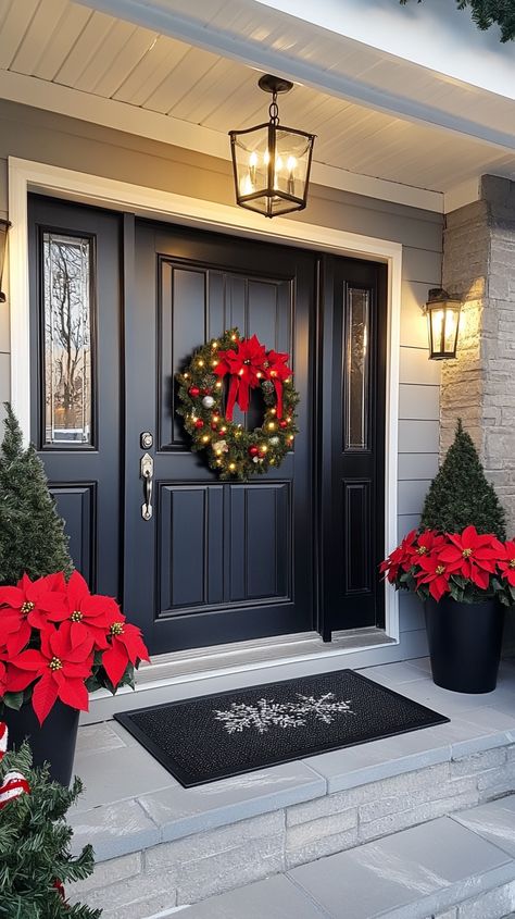 Modern farmhouse porch decorated for Christmas with a wreath, red poinsettias, hanging lights, and black double doors. Outdoor Wreaths On House Christmas, January Front Porch Decor, Outdoor Wreaths On House, Modern Front Door Decor, Decor With Lanterns, Modern Farmhouse Front Porch, Front Door Decor Christmas, Outdoor Christmas Decor Ideas, Outdoor Christmas Decoration Ideas