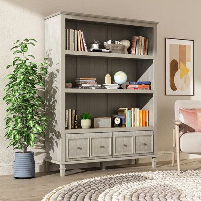 This stylish contemporary farmhouse bookcase is the ideal storage solution for your home office, living room, playroom, or other living space. It has a rustic and charming style, with a natural wood grain look complemented by vintage brass finish drawer pulls that fit seamlessly into almost any decor. The spacious shelves provide a versatile storage and display solution for your TV components, game consoles, audio equipment, DVDs, blu-rays, books, and more. The lower drawer is perfect for puttin Farmhouse Bookcases, Basement Room, Wood Shelving Units, Bookcase Wood, Corner Bookshelves, Tall Bookcases, Furniture Bookshelves, Classic Gray, Wooden Bookcase