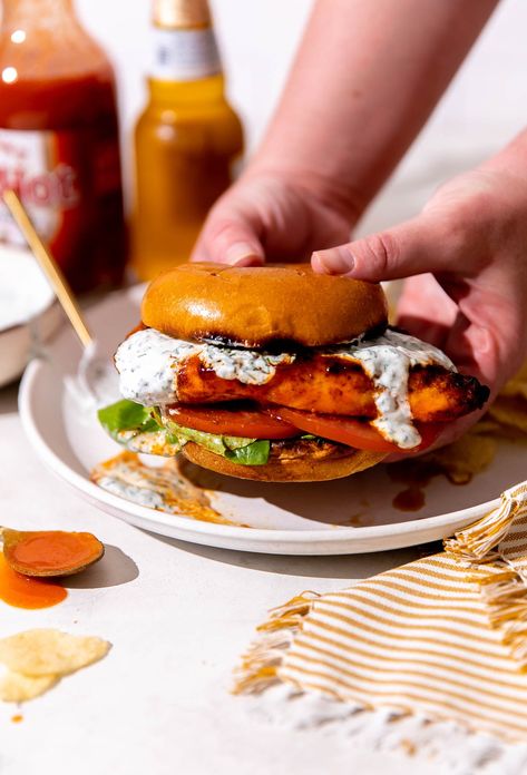 This quick & easy Grilled Buffalo Chicken Sandwich recipe is the perfect summer dinner! Spiced chicken breasts grilled until charred & juicy & finished with homemade buffalo sauce. Serve on brioche buns with an herbed ranch yogurt drizzle & any other buffalo chicken toppers you love. Made in 30 minutes or less, grilled buffalo chicken sandwiches are super quick & delicious! #grilledbuffalochicken #grilledbuffalochickensandwich #buffalochickensandwich #grillingrecipes #grilledchickenrecipes Easy Buffalo Chicken Sandwich, Baked Buffalo Chicken Sandwich, Grilled Cheese Buffalo Chicken, Crispy Buffalo Chicken Sandwich, Grilled Buffalo Chicken Sandwich, Easy Homemade Buffalo Sauce, Buffalo Chicken Breast, Buffalo Chicken Sandwich, Grilled Buffalo Chicken